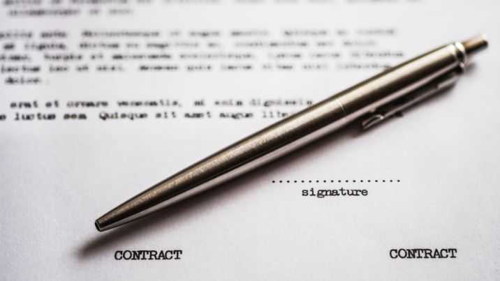 pen lying onto of a business contract